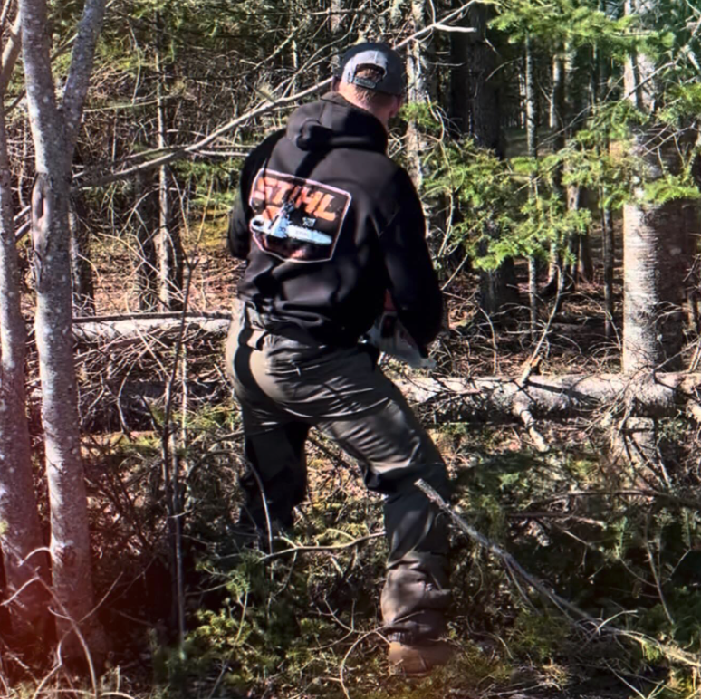 Crew clearing brush and trees in wooded area